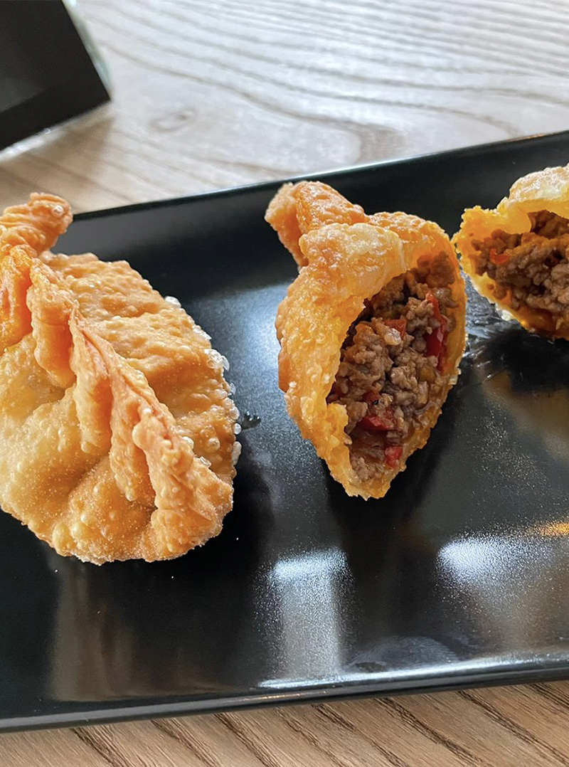 Two fried empanadas filled with meat