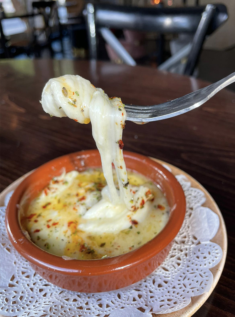 Provoleta - melted provolone cheese with herbs and spices served with bread